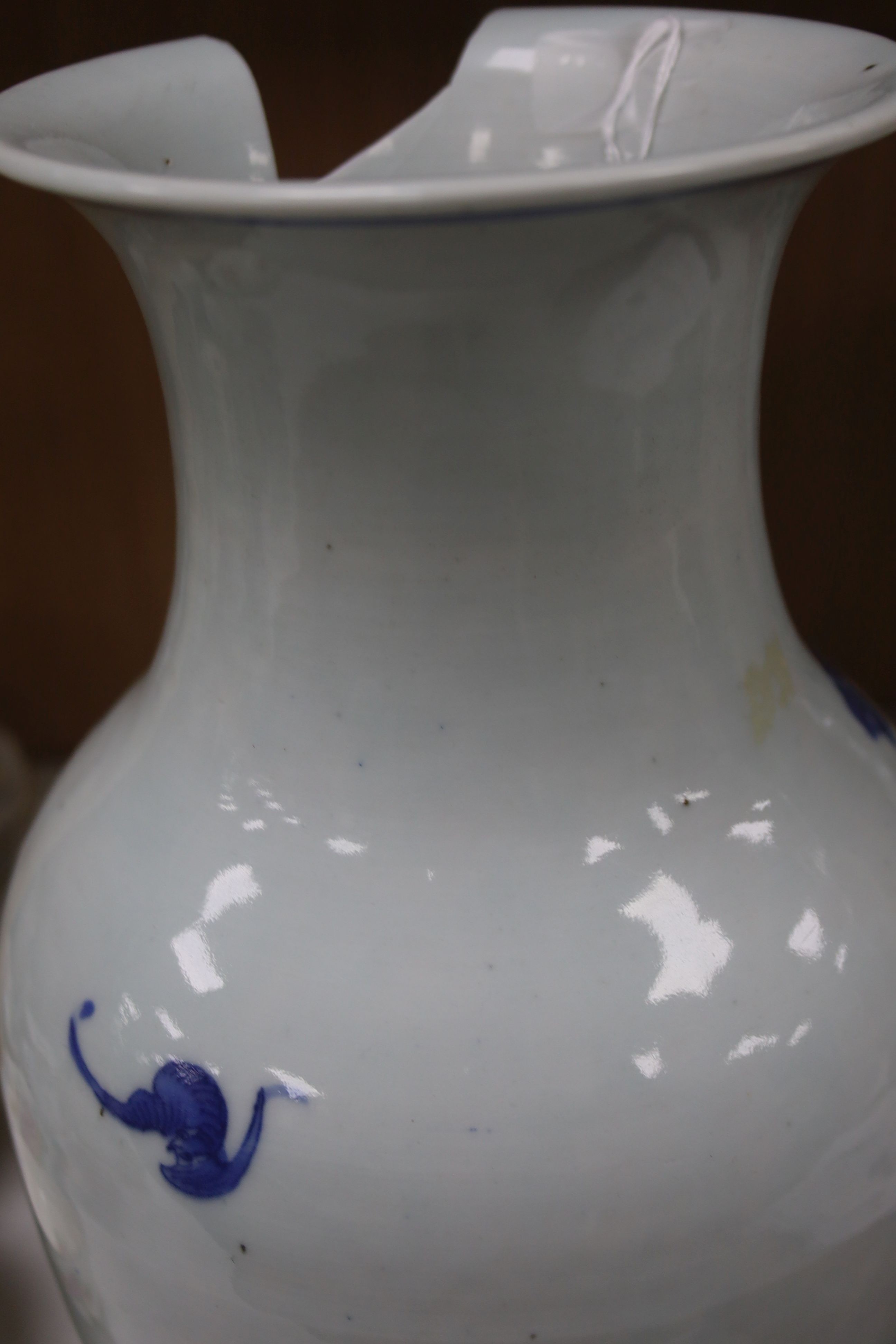 A Chinese blue and white 'Immortals' vase, 18th/19th century, damage, 34.5cm and a Chinese Yongzheng period famille rose ‘phoenix’ vase (reduced in height), 24cm